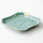 KINTSUGI  Celadon glazed plate with chrysanthemum design, diamond shape, gilt joint